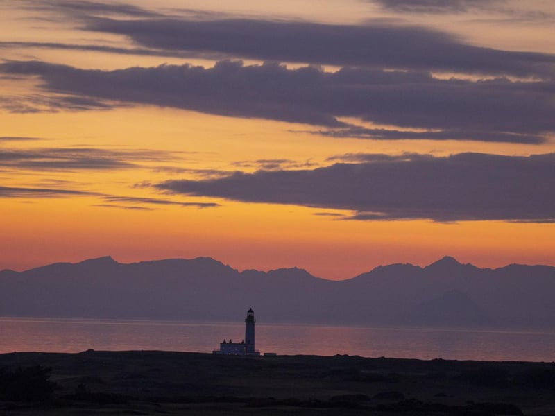The sun going down behind the Trump Turnberry lighthouse cast dazzling dusk colours over the Ayrshire coast