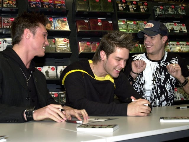 Pop band Phixx - from left, Nikk Mager, Andrew Kinlochlan and Mikey Green - have a laugh whilst signing autographs for fans during their visit to HMV in March 2004.