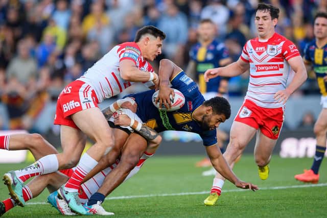 Kallum Watkins is tackled by St Helens' Shane Wright during Leeds Rhinos' 24-16 win last week. Picture by Allan McKenzie/SWpix.com.