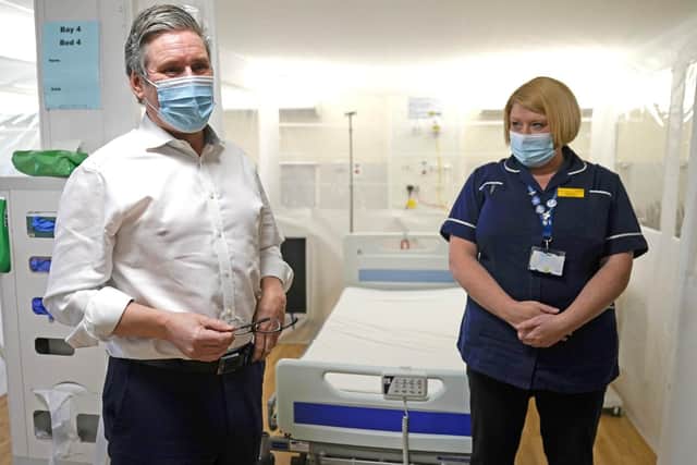 Labour leader Sir Keir Starmer speaking with NHS staff during a visit to Royal Derby Hospital. Sir Keir will target the Government's controversial 1% pay rise for NHS workers during the campaign for the May elections, declaring "a vote for Labour is a vote to support our nurses". (Pic: PA)