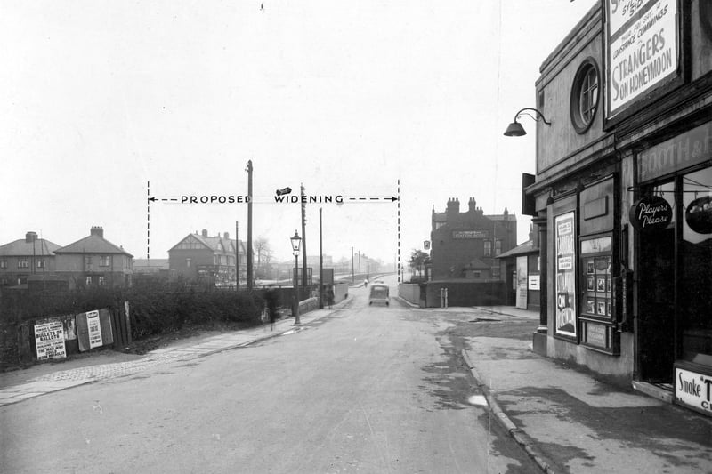 Station Road, across the railway bridge, in April 1937. A measurement on photograph shows extent of size the bridge would be after widening. Houses to the left are on Coldwell Road. To the right is the Station Hotel, a Tetley Public House. Next is the entrance to Cross Gates Station for trains on the North Eastern Railway Line for Leeds and York.