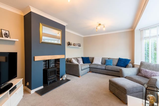 A spacious well-presented living room offers the perfect place for family time, or to enjoy a film.