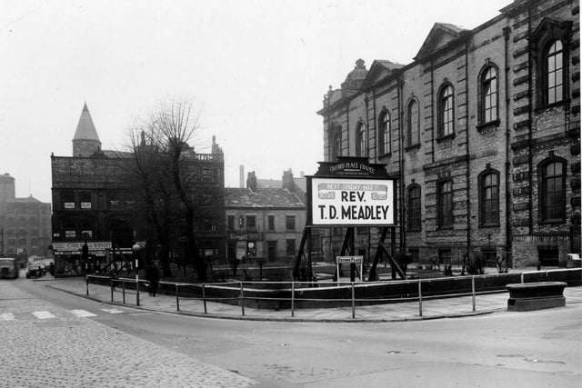 Oxford Place Chapel (Leeds Methodist Mission), on the junction of Park Lane and Oxford Place in February 1953. In the foreground is the chapel's notice board, advertising that the Rev. T.D. Meadley will take services on 1st March. Behind, Carling & Wright (Leeds) Ltd, electrical repairs, can be seen at number 22 Park Lane. Also visible is Savages of Leeds Ltd., motor spares, at numbers 7 and 9 Oxford Row.