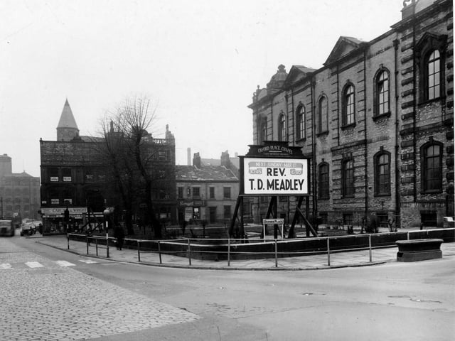 Oxford Place Chapel (Leeds Methodist Mission), on the junction of Park Lane and Oxford Place in February 1953. In the foreground is the chapel's notice board, advertising that the Rev. T.D. Meadley will take services on 1st March. Behind, Carling & Wright (Leeds) Ltd, electrical repairs, can be seen at number 22 Park Lane. Also visible is Savages of Leeds Ltd., motor spares, at numbers 7 and 9 Oxford Row.