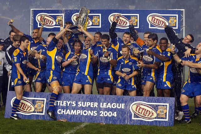Leeds Rhinos celebrate their first Super League Grand Final win in 2004. Rob Burrow is seventh from the left on the front-row, with Barrie McDermott directly behind him. Picture by John Clifton/SWpix.com.