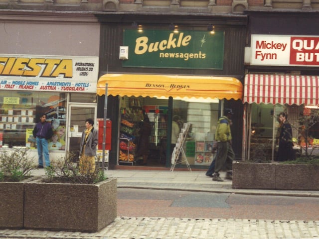 Shops on The Headrow in August 1991. From left is Siesta Holidays, then Buckle newsagents and Mickey Fynn butchers.