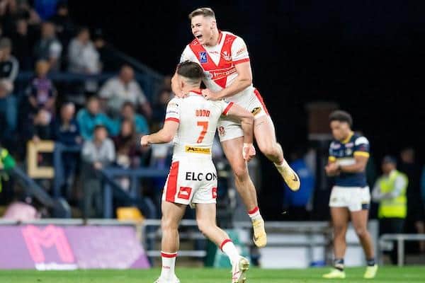 Jack Welsby, right, celebrates with St Helens teammate Lewis Dodd after the latter landed a golden-point drop goal to beat Leeds Rhinos at Headingley 10 months ago. Picture by Allan McKenzie/SWpix.com.