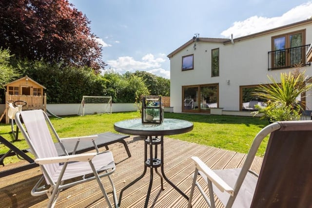 Lawned and landscaped gardens include a decked area and a south-facing, covered sunken terrace.
