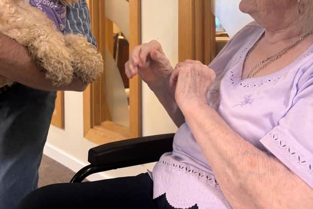 Resident at HC-One’s Augustus Court Care Home with dog, Honey