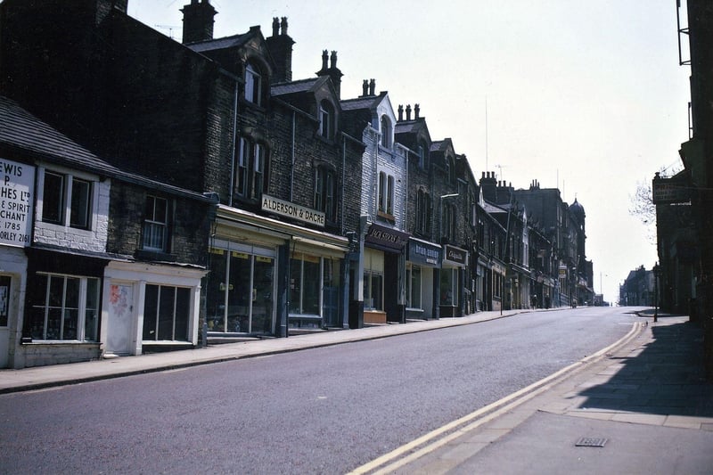 Queen Street looking south towards the Co-op buildings from the entrance to Queensway one Sunday morning in May 1971. The names of shops to be seen on the left are Lewis P. Hughes, Alderson and Dacre, Jack Stocks, Brian Senior and Chiquita.