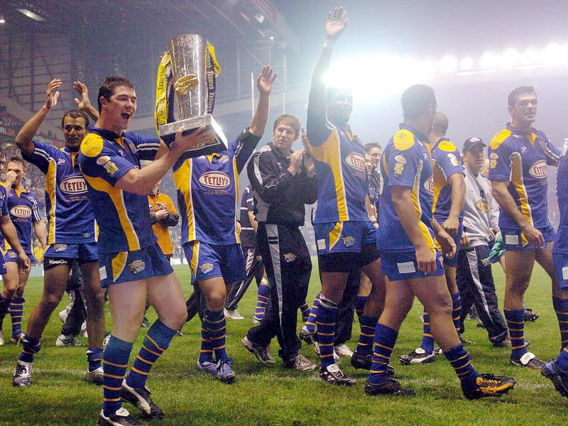 Richard Mathers with the trophy as Leeds Rhinos players celebrate their Grand Final victory over Bradford Bulls 20 years ago.