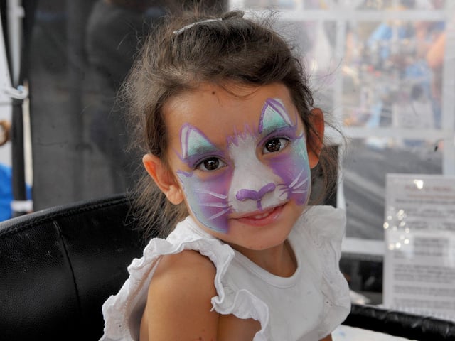 Betsy Allen, aged three, enjoying having her face painted