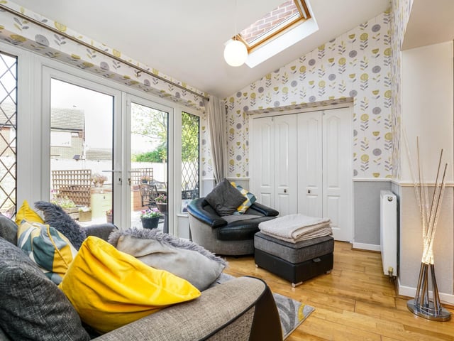 Parallel to the kitchen is the living room with an open plan living area for relaxing and a fireplace.