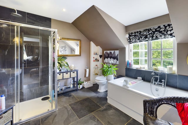 This bathroom has both a walk-in shower and a bath with central mixer tap.