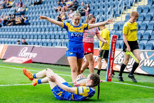Liv Whitehead (standing) celebrates a try by Sophie Nuttall in Leeds Rhinos' home win against Leigh Leopards last month. Picture by Allan McKenzie/SWpix.com.