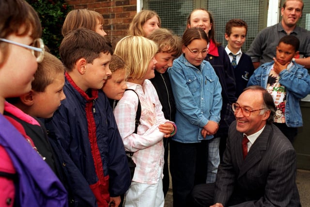 Home Secretary Michael Howard talks with members of an eight-to-13-year-old  after school group at the Seacroft Project Base during his visit to the Seacroft estate in September 1996.