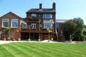 A raised sun terrace with pagoda is a feature of the rear lawned garden that has open views.