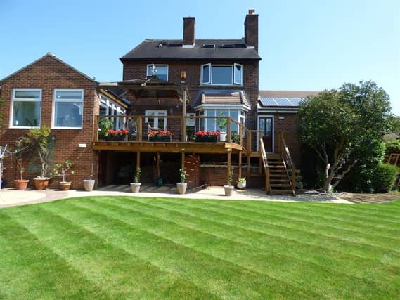 A raised sun terrace with pagoda is a feature of the rear lawned garden that has open views.