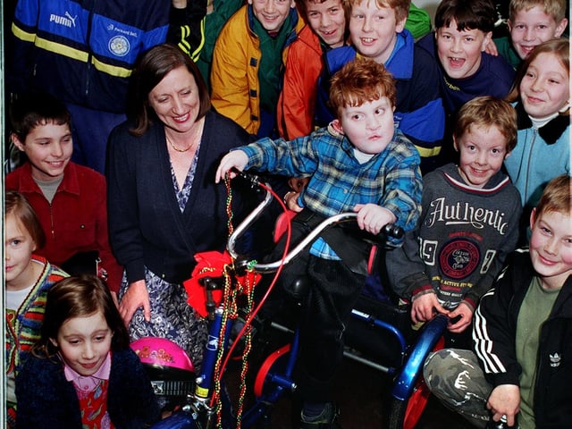 Charles Payne with sporting youngsters after receiving his new bike at Kippax Welfare and Social Club in December 1998. He is pictured with mum Barbara.