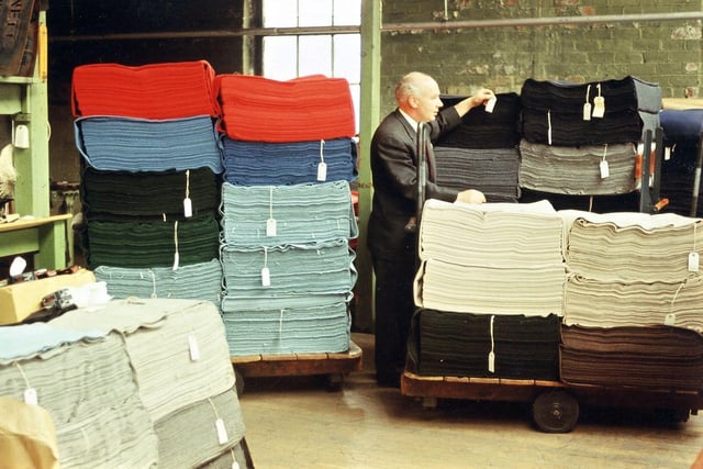 Finished lengths of cloth ticketed and ready for final despatch being examined by the cloth warehouse manager, Bob Kirk. This was important as it would affect the amount of space taken up on a ship if for export, or the number of bales that could be got into a container. The warehousing and packaging department was in an adjoining mill along Victoria Road that the Prospect took over when it went out of business in the 1920s.