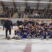 CHAMPIONS: Leeds Knights' players and staff - including head coach Ryan Aldridge (far left) celebrate at Elland Road Ice Arena last night. Picture: Phil Harrison.