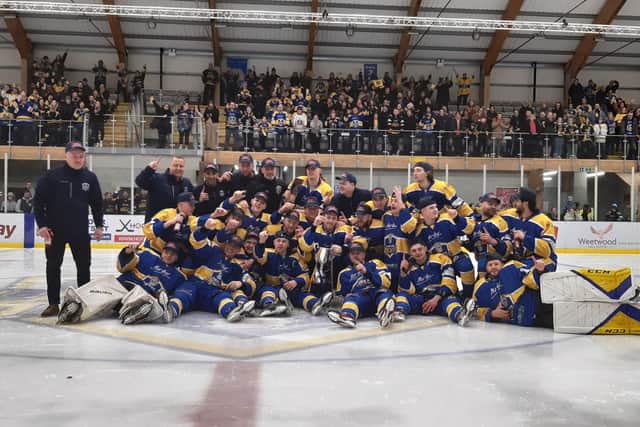 CHAMPIONS: Leeds Knights' players and staff - including head coach Ryan Aldridge (far left) celebrate at Elland Road Ice Arena last night. Picture: Phil Harrison.