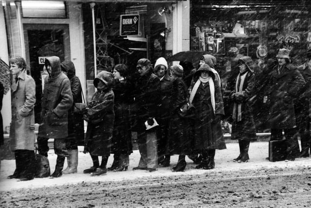 The snow lashes down on shoppers queuing for a bus on Boar Lane as the city evening rush hour begins in February 1979.