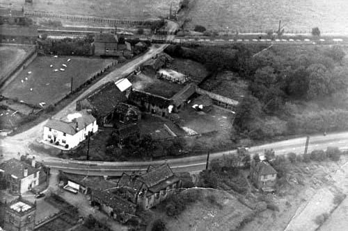 An aerial view of Cardigan Arms in the 1950s.  In the bottom left hand corner the tower of St. Mary's Church is visible and just above is St. Mary's Church Vicarage. In the centre of the bottom is St. Mary's Church Sunday School, and to the right of it a house called Hillside.