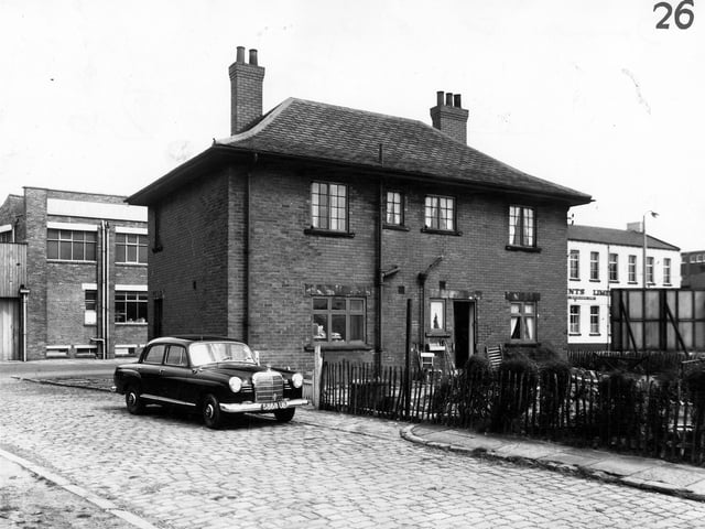 A view looking from Blackburn Street onto the back entrance and garden of number 95 Whitehall Road in March 1965. This property also had an entrance to the side which led to Dr J.E. Rusby's surgery. On the cobbled street a 1958 Mercedes Benz 180D is parked.