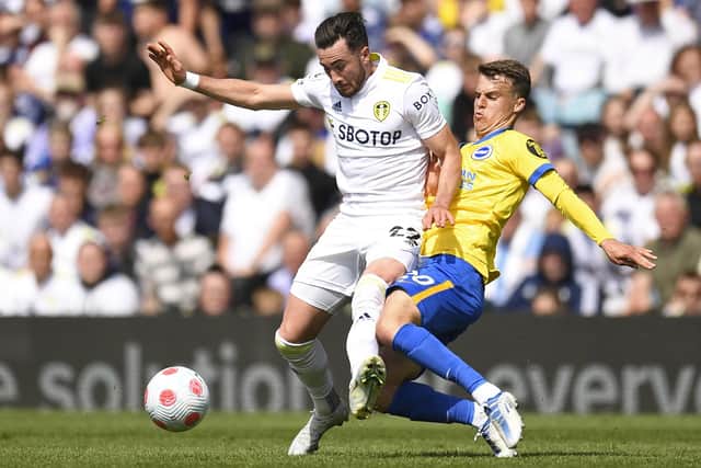 Leeds United's English midfielder Jack Harrison (L) is tackled by Brighton's English midfielder Solly March (R) during the English Premier League football match between Leeds United and Brighton and Hove Albion at Elland Road in Leeds, northern England on May 15, 2022.