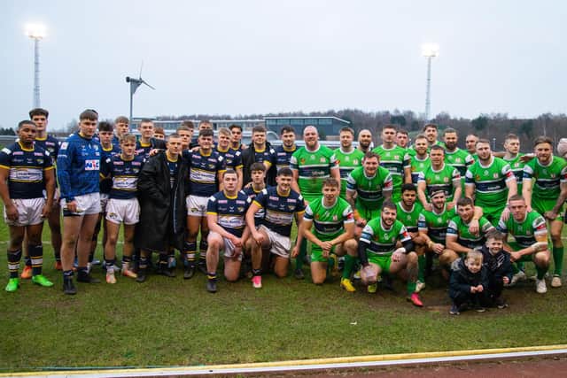 Rhinos (in blue) and Hunslet players line up together after the hosts' win in the Harry Jepson OBE Memorial Trophy tie. Picture by Craig Hawkhead/Leeds Rhinos.
