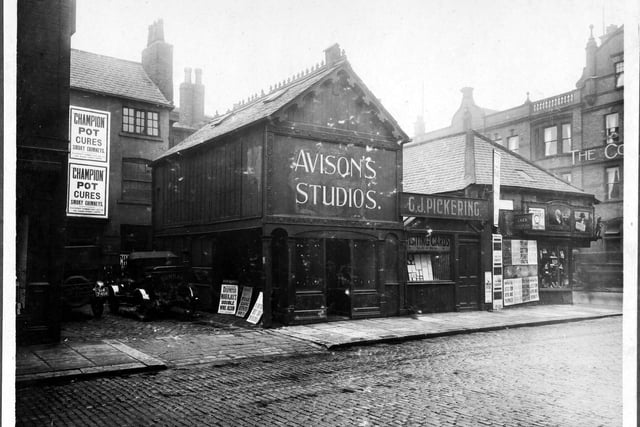 September 1927 and in focus is the junction of Albion Street with Guildford Street (Headrow). The Commercial Hotel can be seen. Number 109 Albion Street, John Pickering printer. Number 107, Avison's Studio, Edwin Avison photographer, number 105 premises used by Patent Chimney Pot Company. Whose posters are visible, Allied News Ltd, poster for 'Daily Despatch' and the Antique Reproduction Silver Plate manufacturers.