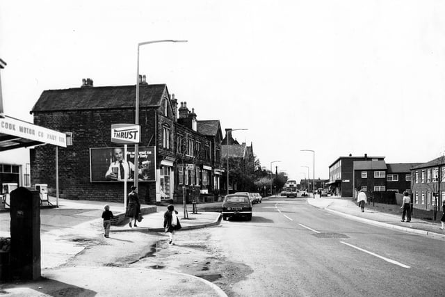 Upper Town Street in May 1979. On the left is a garage then a row of shops including Severn Sports. On the right is the junction with Bell Road then another parade of shops.