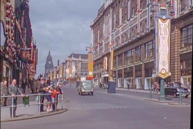 Looking west along The Headrow from the junction with Briggate. Lewis’s department store is on the right. Decorations can be seen to celebrate the coronation of Queen Elizabeth II, which took place on June 2, 1953.