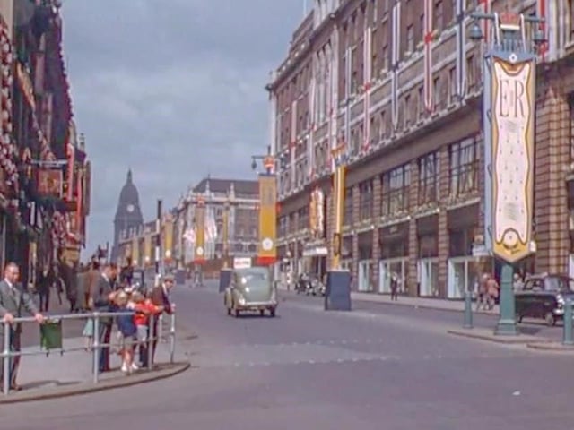 Looking west along The Headrow from the junction with Briggate. Lewis’s department store is on the right. Decorations can be seen to celebrate the coronation of Queen Elizabeth II, which took place on June 2, 1953.