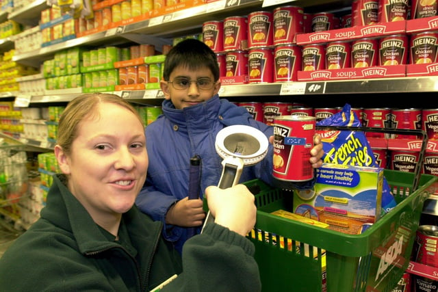 Asda at Killingbeck, Leeds, helping people who are partially sighted to label their products with the store's new handheld braille gun. Pictured left, Jo Carroll from Asda and Harjinder, eight, a pupil at Talbots Primary School, Leeds, on January 25, 2001.