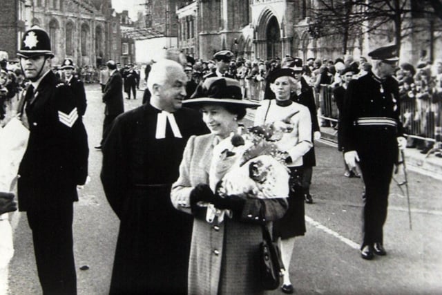 The Queen pictured during a walkabout in Deansgate in November 1984 accompanied by the Dean of York, the very Rev. John Southgate. Behind , Right, is York Minster's south transept, where she attended a service of rededication for its restoration form the fire of 1984.