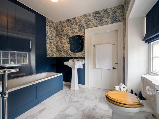There is a shower room in addition to this spacious house bathroom.