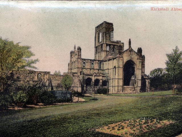 A colour-tinted postcard view of Kirkstall Abbey with a postal date of April 20, 1908.