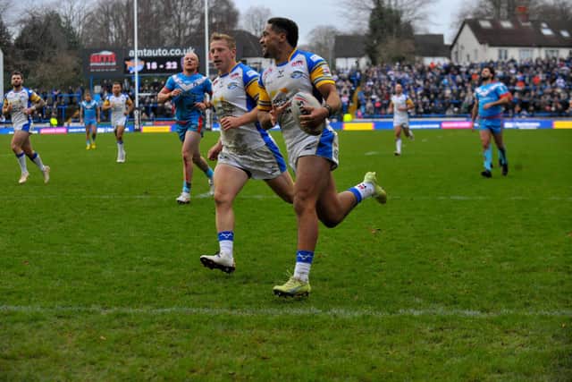 Derrell Olpherts scores for Rhinos in their pre-season win against Wakefield Trinity. Picture by Steve Riding.