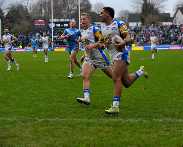 Derrell Olpherts scores for Rhinos in their pre-season win against Wakefield Trinity. Picture by Steve Riding.