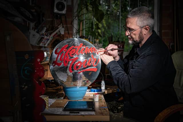 Mirrorball artist and signwriter Kieran Hadley working in his studio in Leeds on a miirorball for American singer, songwriter, Katy Perry on her current world tour 'The Lifetimes Tour'. Photograph by Tony Johnson.