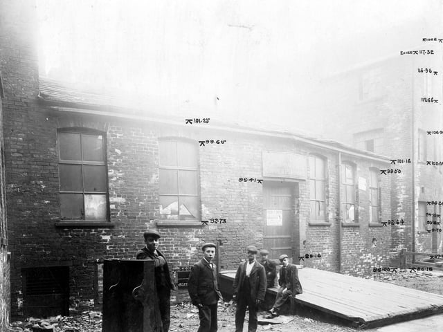 Tenter Lane had been the premises of Frederick Ripley Smith, tin plate worker. The property was to be demolished as part of the Swinegate/Sovereign Street improvements. Workmen, in dress of the period, pose for the photograph.