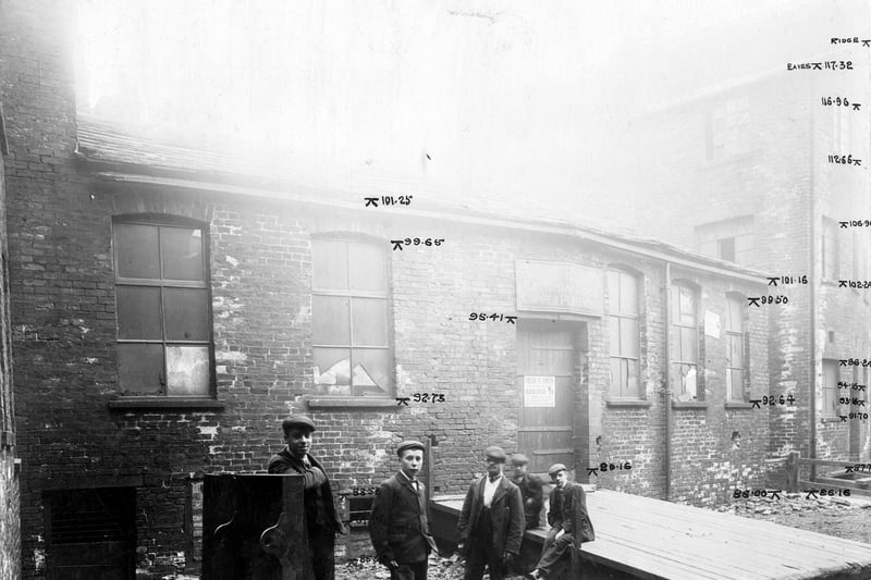 Tenter Lane had been the premises of Frederick Ripley Smith, tin plate worker. The property was to be demolished as part of the Swinegate/Sovereign Street improvements. Workmen, in dress of the period, pose for the photograph.