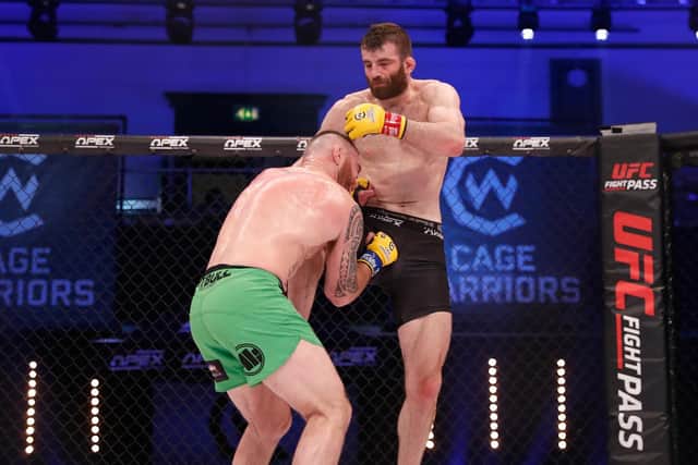 FIGHTING FIT - Leeds United fan George Smith, seen here in Cage Warriors MMA action, has recovered from heart surgery and is preparing for a return to the cage. Pic: Dolly Clew
