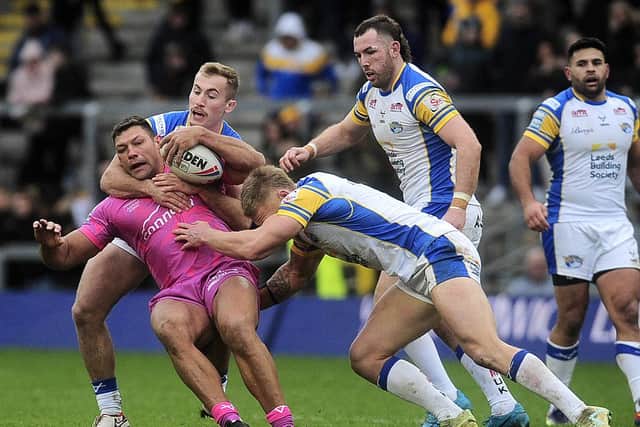 Hull KR's former Leeds Rhinos winger Ryan Hall is tackled by Jarrod O'Connor and Mikolaj Oledzki as Cameron Smith and Rhyse Martin look on. Picture by Steve Riding.