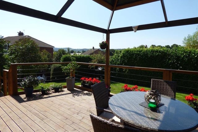 Far reaching views extend beyond the property's garden with raised decking.