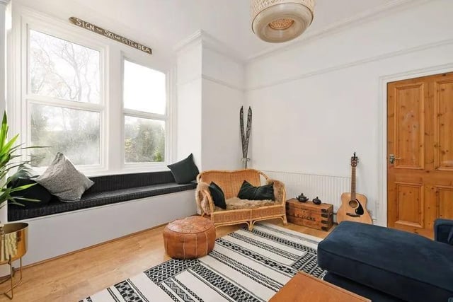 The room also features double glazed sash windows, wood effect laminate flooring, feature fireplace with cast iron insert with tiling, black surround and slate hearth.
