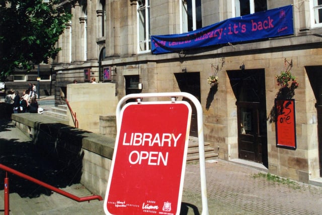 Municipal Buildings on The Headrow in June 2000 at the time of the return of the Central Library to the building after 10 months in the Town Hall while essential works were carried out. A sign says 'Library Open' while a banner on the wall proclaims 'Leeds Central Library: it's back'. Several changes had been made while the building was closed, including the departure of the museum and the addition of the Art Library, forming a new Arts Floor with the Music Library.