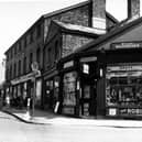 Tobacconists B. Murgatroyd on the corner of Town Street and Carr Crofts in May 1955. Advertisements for various tobaccos in the window and adverts for the Empire theatre on the wall. Progress Stores is also visible.